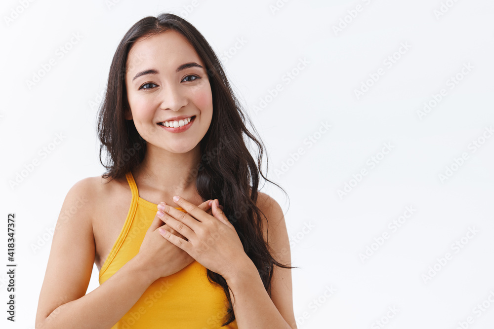 Close-up grateful, tender young east-asian woman feeling touched and flattered, smiling and gazing with affection, touch heart, express gratitude and delight of receiving nice gift, white background Close-up grateful, tender young east-asian woman feeling touched and flattered, smiling and gazing with affection, touch heart, express gratitude and delight of receiving nice gift, white background