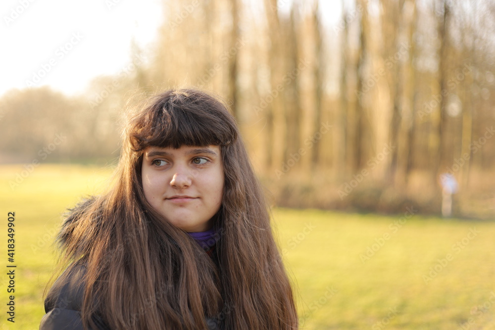 close up smiling portrait of girl, young woman outdoor, green grass background, sunny day close up smiling portrait of girl, young woman outdoor, green grass background, sunny day