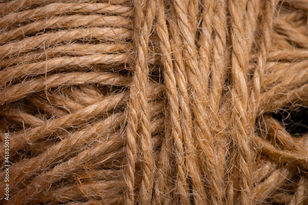 Fototapeta premium Close-up view of natural twine wound on a card. Craft background