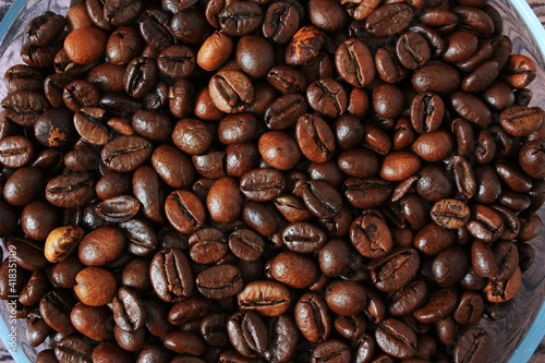 Brown coffee beans on a plate