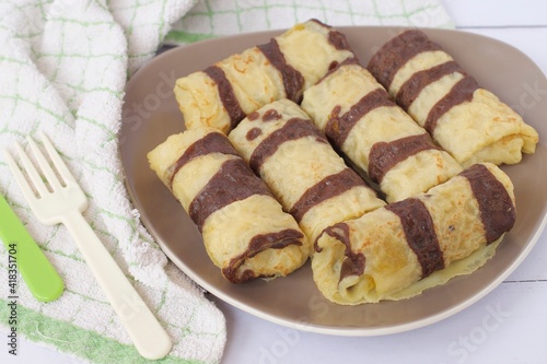 Dadar Gulung or Rolled pancakes are a typical Indonesian and Malaysian food which can be classified as a pancake filled with grated coconut mixed with liquid Javanese sugar. 