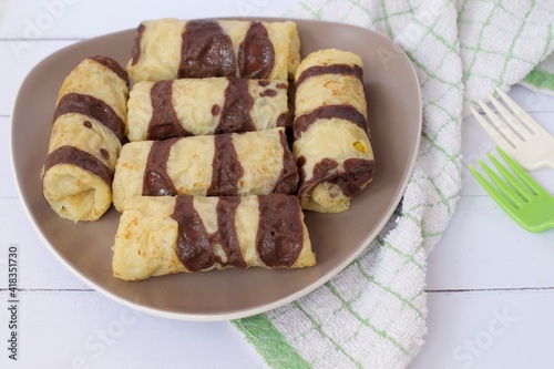 Dadar Gulung or Rolled pancakes are a typical Indonesian and Malaysian food which can be classified as a pancake filled with grated coconut mixed with liquid Javanese sugar. 