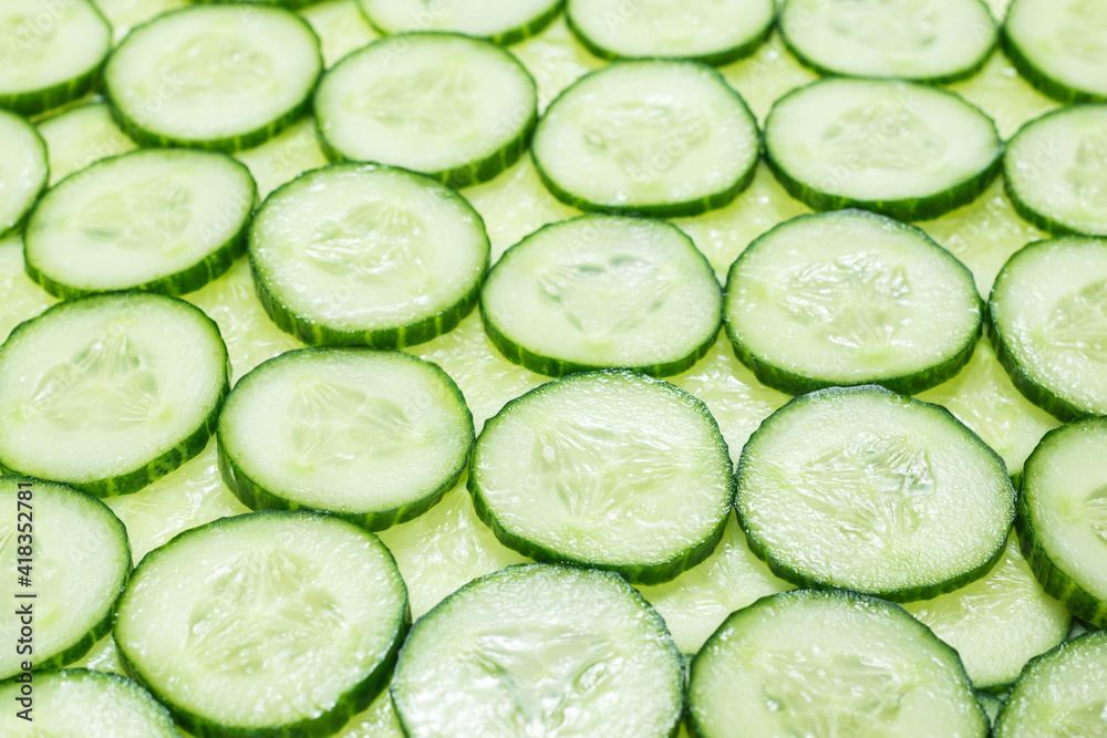 Fresh green slices of cucumber as background. Fresh green slices of cucumber as background.