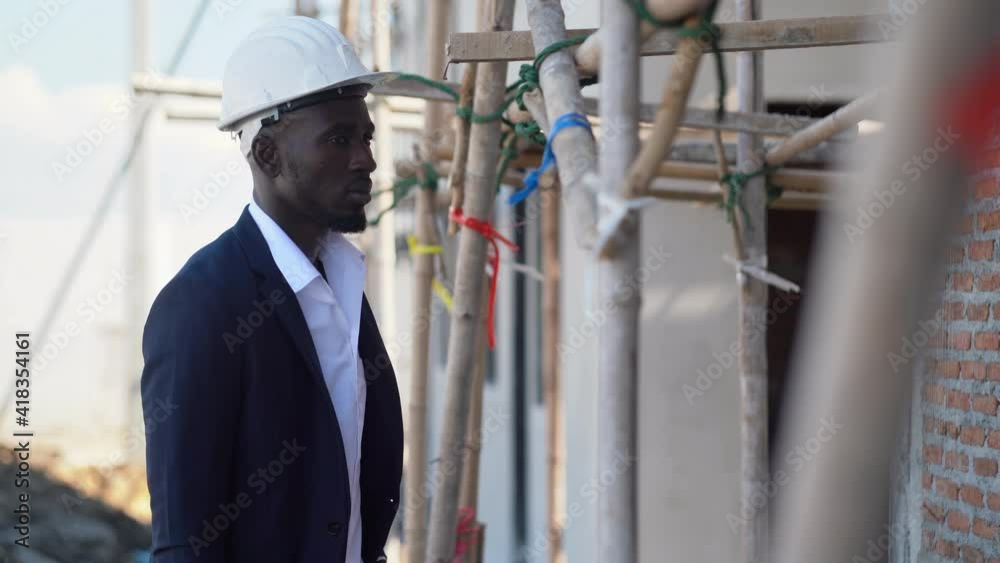african american architect checking construction site outdoors at ...