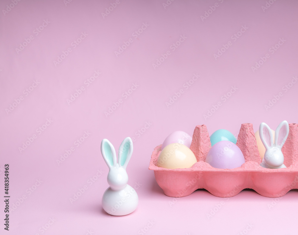 Easter colorful photografie with eggs group and bunny egg  on pink background, copy space 