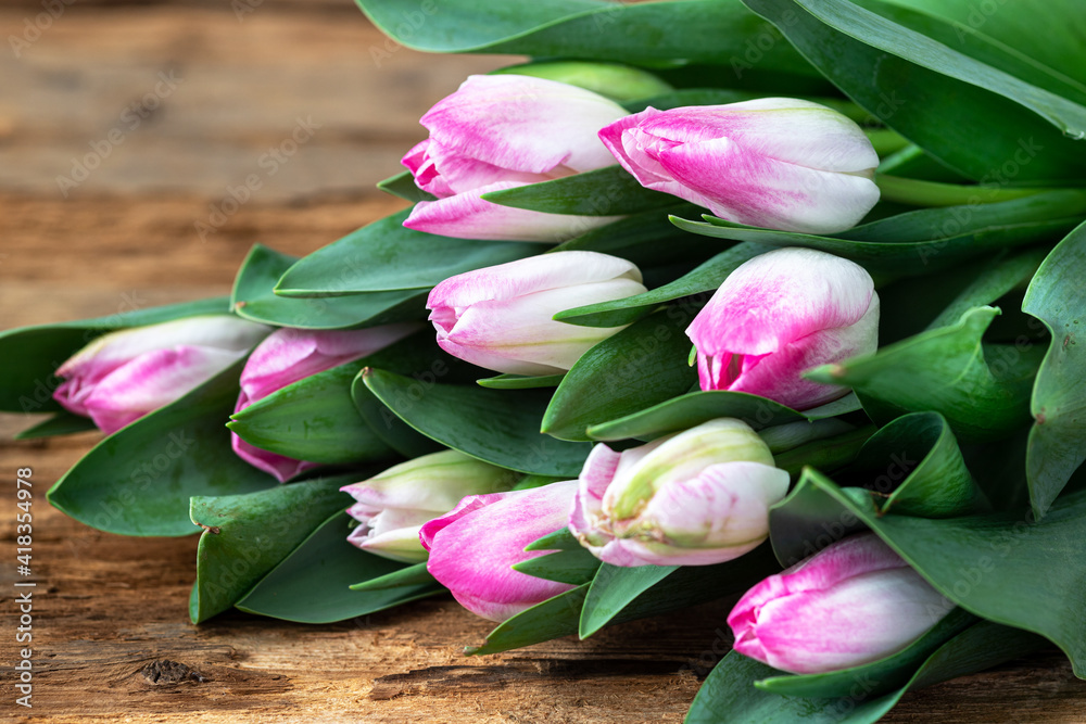 Bouquet of beautiful pink tulips on wooden background