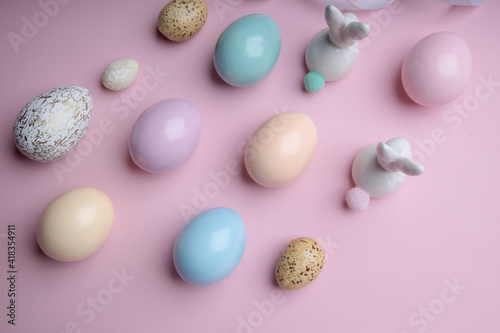 Easter colorful photografie with eggs group and bunny egg on pink background, copy space 