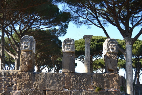 Ancient theater masks and statues in old amphitheater in ostia Antica Rome Italy 