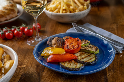 Grilled bbq vegetables. Eating vegan food in restauran with friends. Enjoying vegan dishes out home. Selective focus