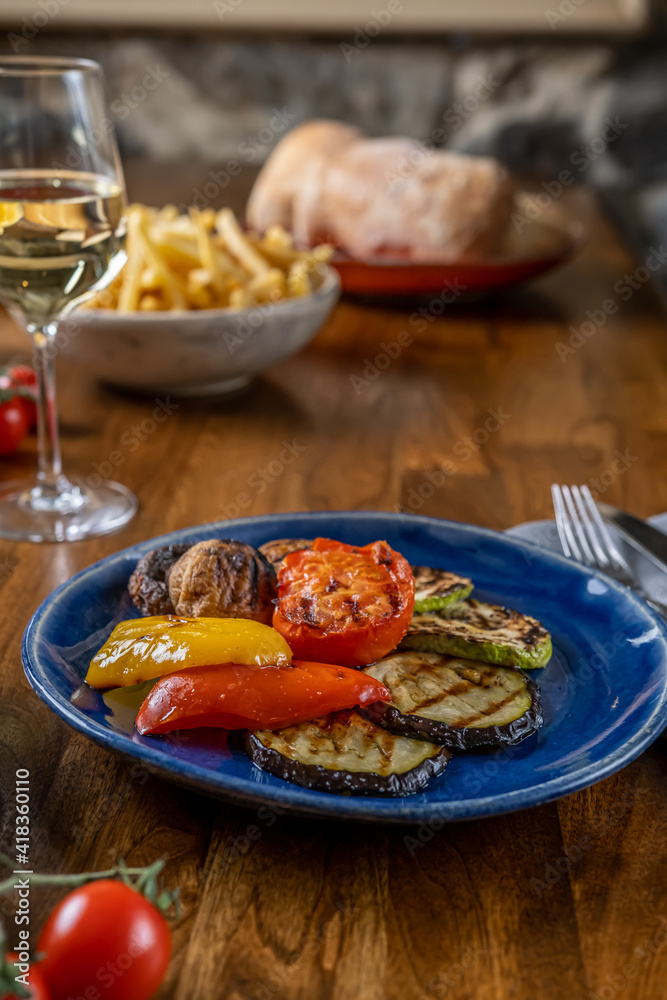 Grilled bbq vegetables. Eating vegan food in restauran with friends. Enjoying vegan dishes out home. Selective focus