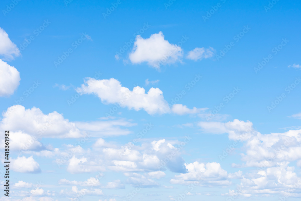 Lots of cumulus clouds far on horizon on blue daylight sky as natural background Lots of cumulus clouds far on horizon on blue daylight sky as natural background