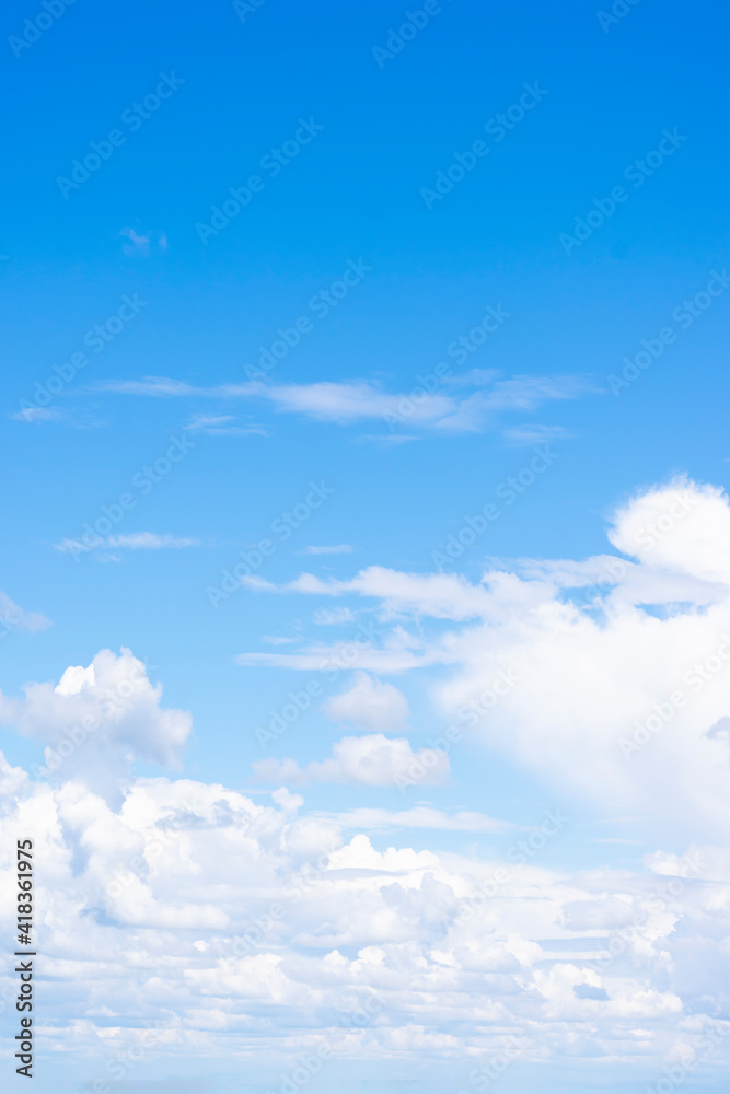 Vertical format of background made of cumulus clouds on blue sky with gradient far away, horizon. Copy space Vertical format of background made of cumulus clouds on blue sky with gradient far away, horizon. Copy space