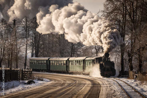 Old train with big smoke during winter time in Moldovita, Bucovina. Romaniia.
