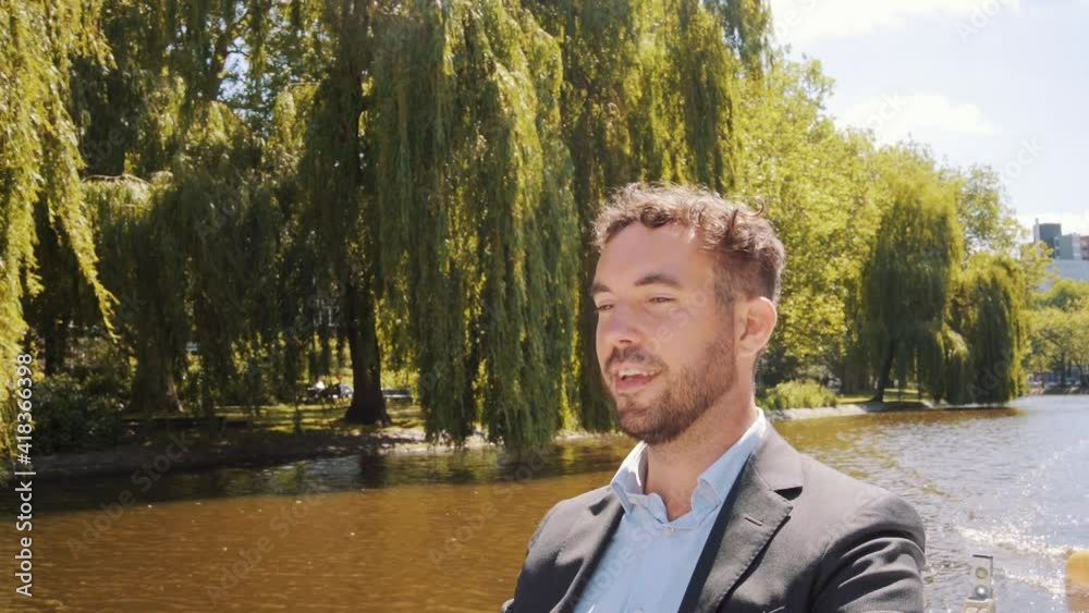 Close up of young white man dressed in formals, enjoying in water canal. Close up of young white man dressed in formals, enjoying in water canal.
