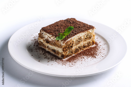 Tiramisu dessert with mint isolated on white background.