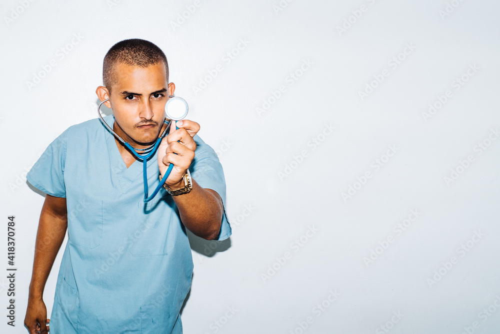doctor looking at camera holding a stethoscope. health concept.
