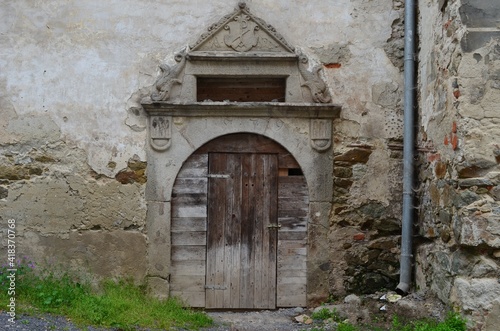old wooden door in the wall with an arch  Bansk   Stiavnica  Slovakia 