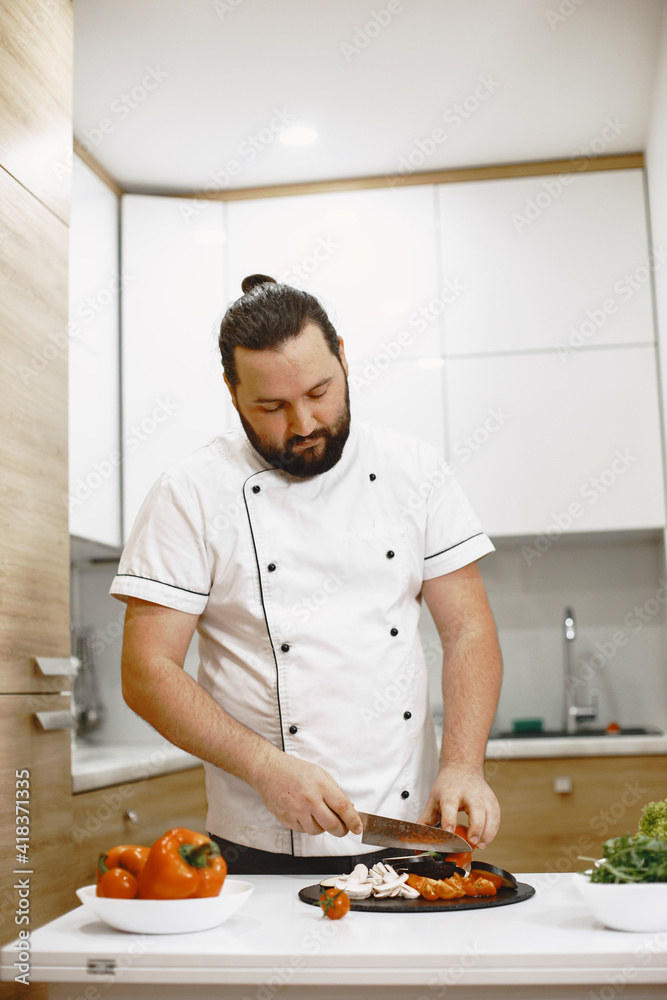Taking care of his health. Handsome guy standing in the kitchen at home. Taking care of his health. Handsome guy standing in the kitchen at home.