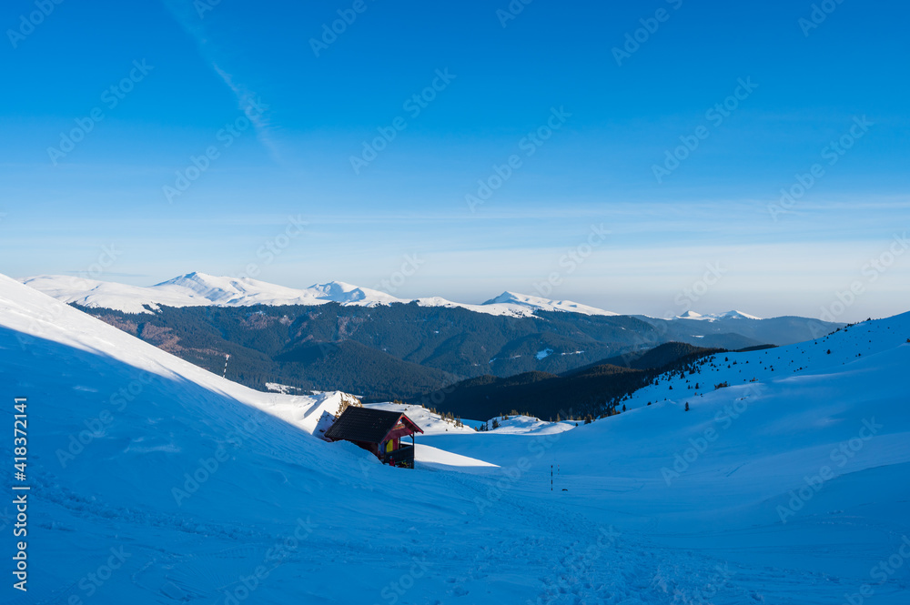 Alpine hut in the snow-covered Bucegi mountains in Romania