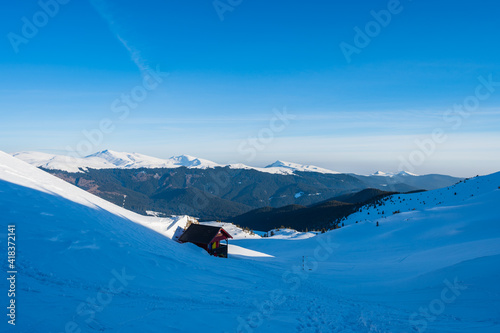 Obraz na płótnie Alpine hut in the snow-covered Bucegi mountains in Romania w salonie