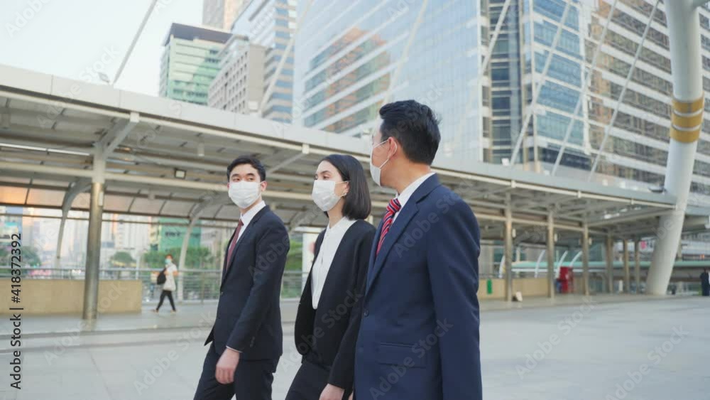 Group of business people wearing face mask walking outdoor in the city Group of business people wearing face mask walking outdoor in the city