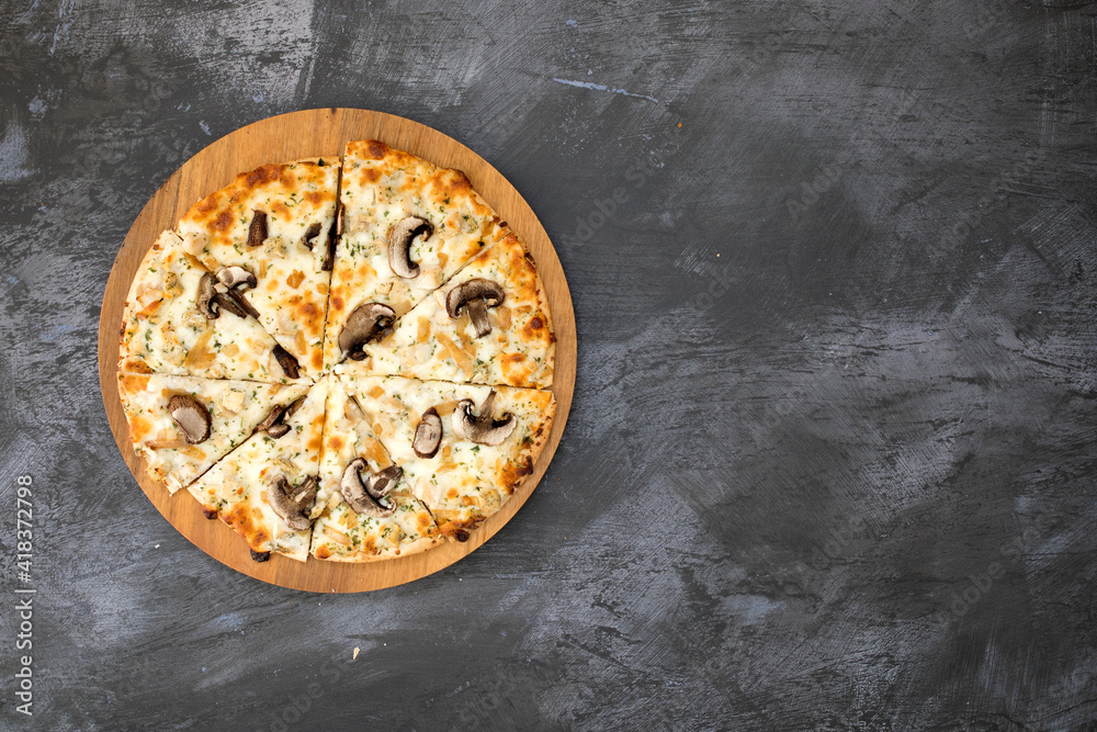 A Mushroom Pizza on a Concrete Background with Room for Copy