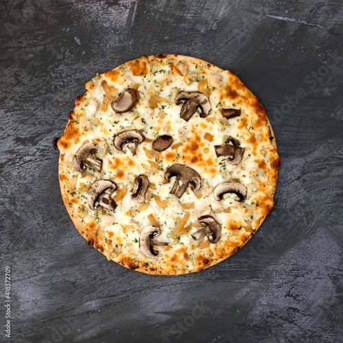 A Mushroom Pizza on a Concr...