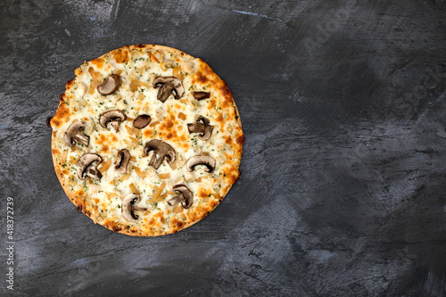 A Mushroom Pizza on a Concr...