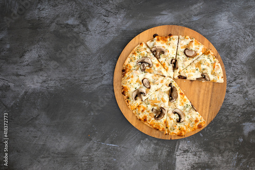 A Mushroom Pizza on a Concrete Background with Room for Copy