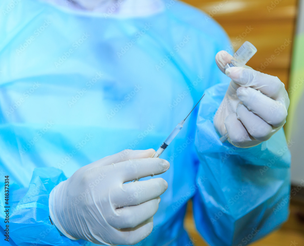 Covid-19 vaccine, doctor with syringe