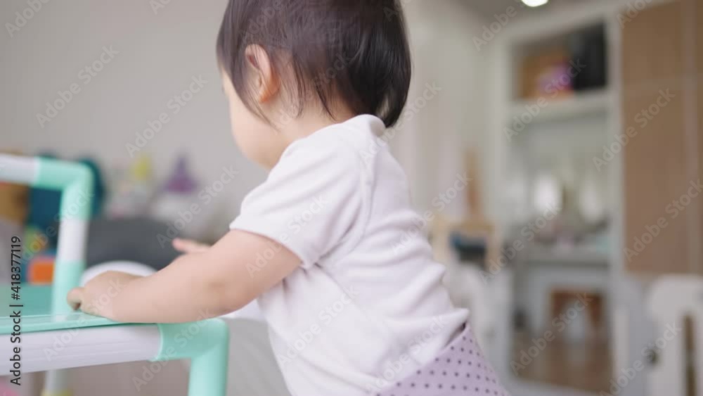 Asian baby girl playing around inside condo apartment bedroom, kids playground at home, child toys online ordering, happy positive energy from young age, children emotion sensitivity study concept Asian baby girl playing around inside condo apartment bedroom, kids playground at home, child toys online ordering, happy positive energy from young age, children emotion sensitivity study concept