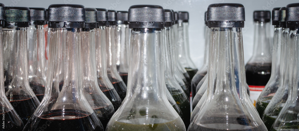 Glass bottles with lids and dark liquid. Drying oil, paint. Glass bottles with lids and dark liquid. Drying oil, paint.