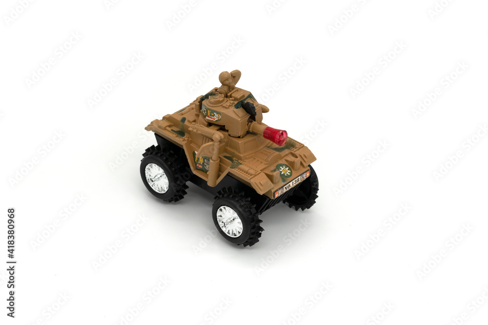 Plastic model of a military toy car isolated on white background.