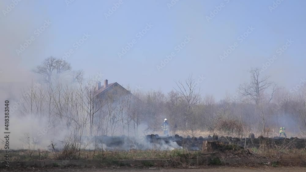 Fire grass near the forest. Thick smoke and fire threaten nature and the city. Fire grass near the forest. Thick smoke and fire threaten nature and the city.