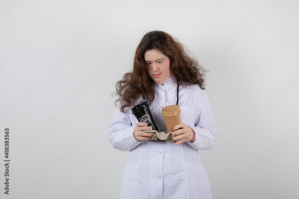 Picture of a young girl model in white uniform holding a cardboard Picture of a young girl model in white uniform holding a cardboard