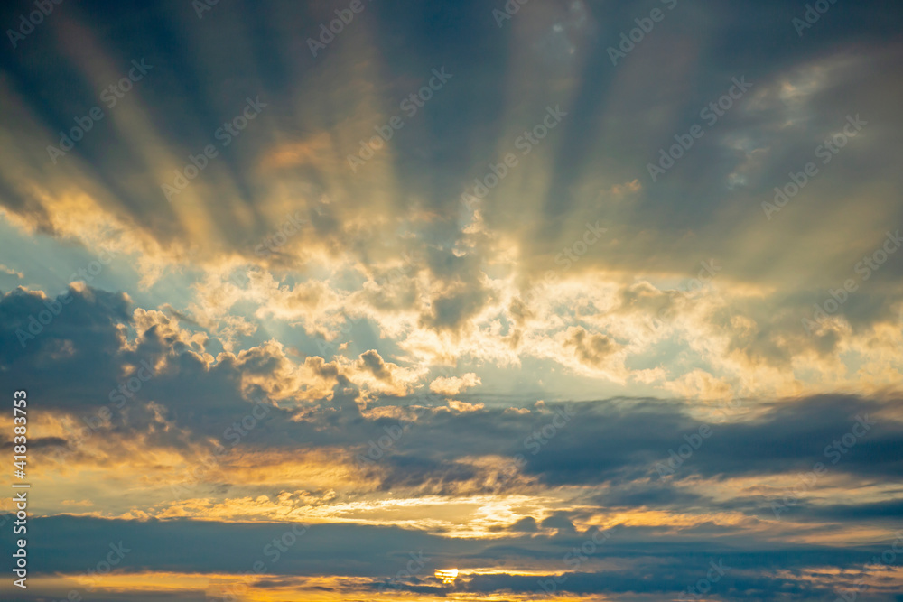 Fototapeta premium Runrays seen coming through the clouds during sunset in Estonian nature