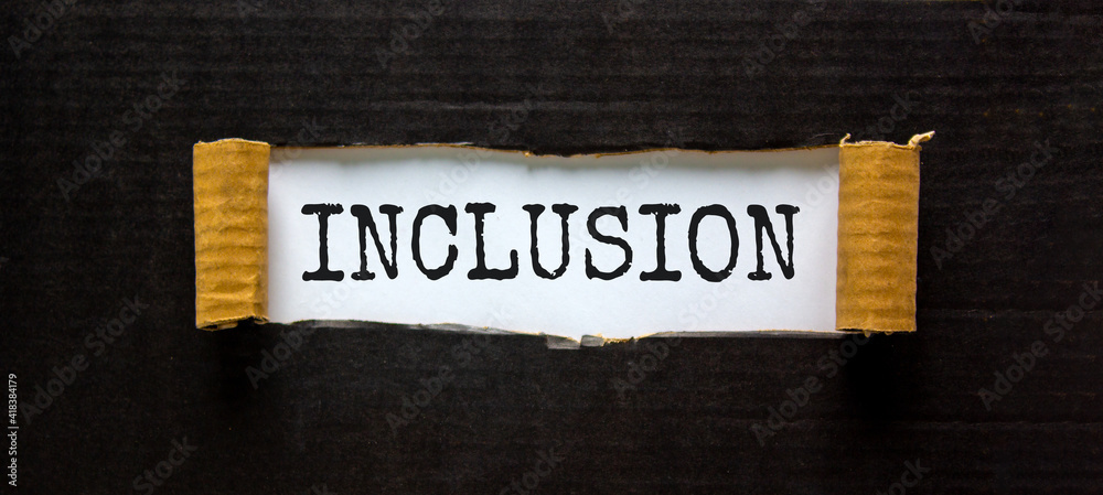 Obraz premium Belonging and inclusion symbol. The word 'inclusion' appearing behind torn black paper. Beautiful black background. Business, inclusion and belonging concept. Copy space.