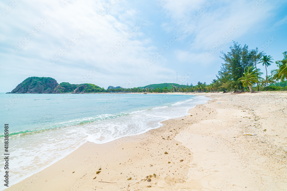 Secluded tropical beach turquoise transparent water palm trees, Bai Om undeveloped bay Quy Nhon Vietnam central coast travel destination, desert white sand beach