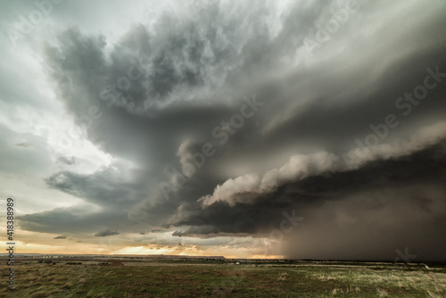 Tornadic supercell in western Oklahoma creates a dramatic landscape scene. Massive hail and small tornado during storm, USA photo