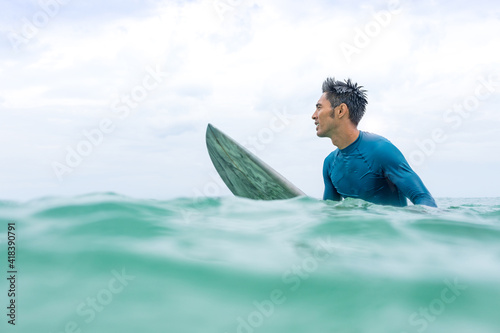 Surfer waiting in sea, Pagudpud, Ilocos Norte, Philippines photo