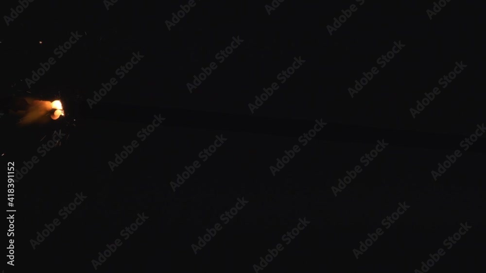 Christmas sparkler on black background, slow motion