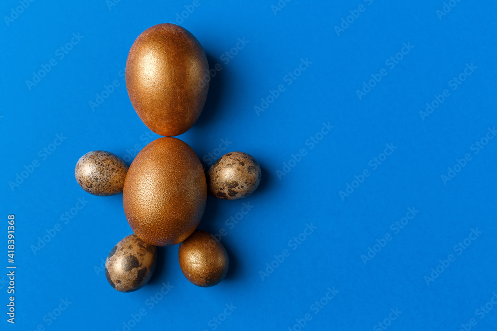 Golden modern easter eggs on a blue background. Easter concept. Isolated. Golden modern easter eggs on a blue background. Easter concept. Isolated.