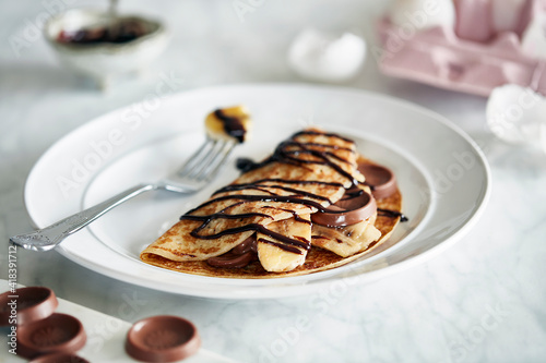 Banana chocolate pancake with chocolate sauce photo