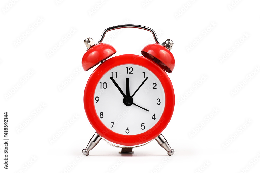 Red retro style alarm clock with timer close before 12 isolated on white background Red retro style alarm clock with timer close before 12 isolated on white background