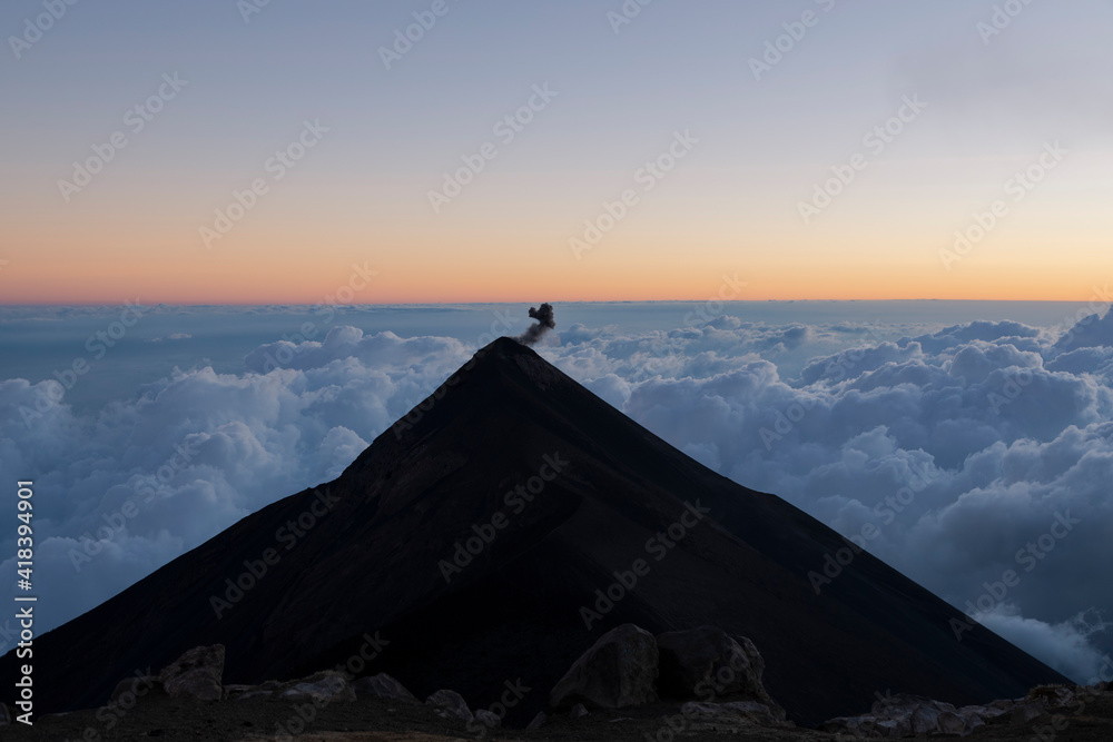 Sunset at Volcan Acatenango with view towards the Fire volcano erupting in Guatemala with the sky of colors