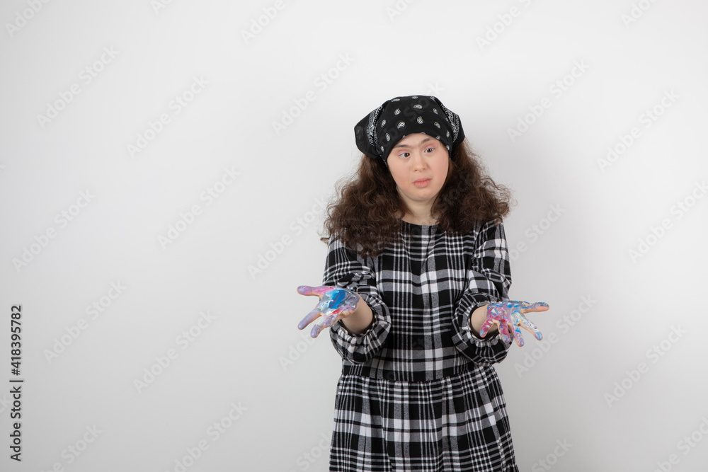 Young girl with down syndrome showing colors on white background Young girl with down syndrome showing colors on white background
