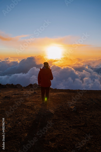 Climber on top of Acatenango volcano in Guatemala watching the sunset - woman hiking on top of the volcano at sunset © Fernanda