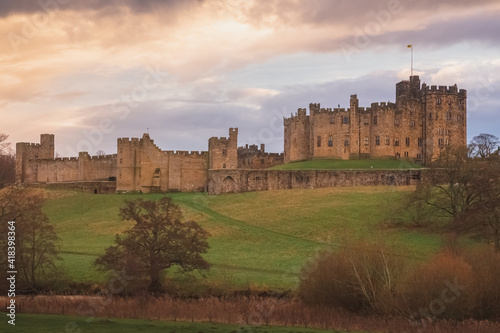 Dramatic and colourful sunset or sunrise clouds above the River Aln and Alnwick Castle, England. photo