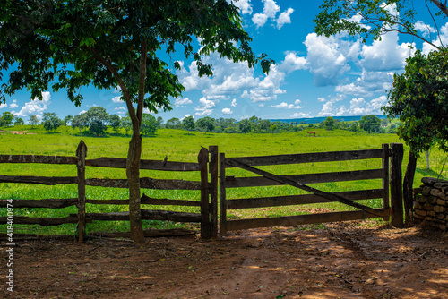Wooden fence and old farm gate in the nature background