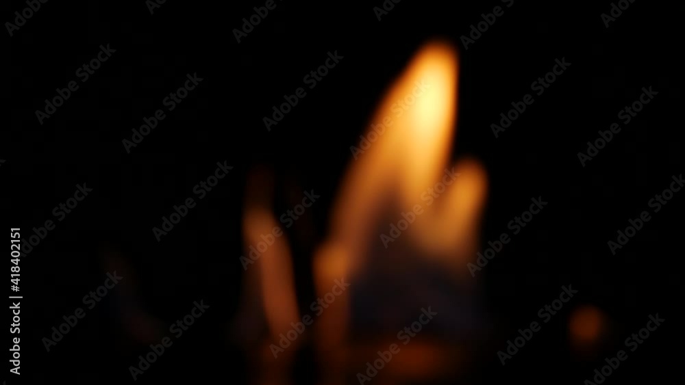 Close up of golden flames with black background Close up of golden flames with black background